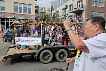 Houseparent Philip watches the St. Joseph’s Indian School entries pass by in the Sioux Falls Native American Day Parade. The school’s floats honored the buffalo, the natural world and Lakota values.
